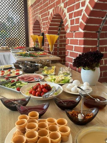 a table with many plates of food on it at MOY Beldibi Hotel in Antalya