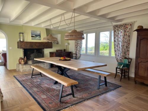 un salon avec une table et une cheminée dans l'établissement Belle maison familiale vue sur mer, accès direct à la plage, à Pleumeur-Bodou