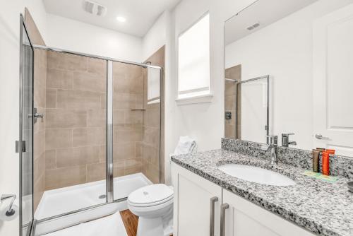a bathroom with a shower and a toilet and a sink at Beautiful House with Pool in Reunion Orlando 10 minutes from Disney in Orlando