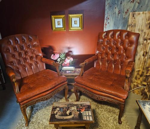 two leather chairs and a table in a living room at Base apartments ap 207 - Capital region of Reykjavík in Hafnarfjördur