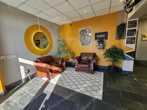 a waiting room with leather chairs and a mirror at Base apartments ap 207 - Capital region of Reykjavík in Hafnarfjördur
