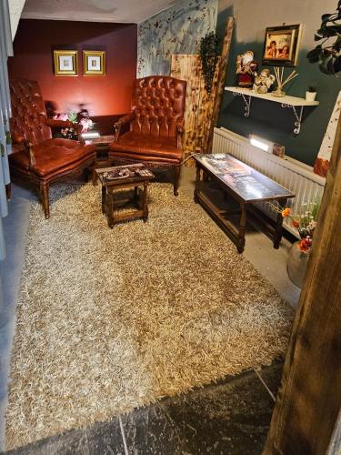 a living room with leather furniture and a large rug at Base apartments ap 207 - Capital region of Reykjavík in Hafnarfjördur
