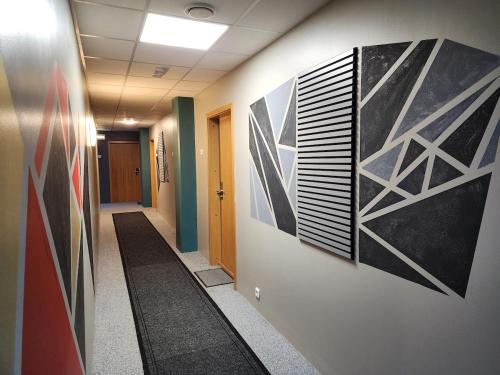 a hallway of an office with paintings on the wall at Base apartments ap 207 - Capital region of Reykjavík in Hafnarfjördur