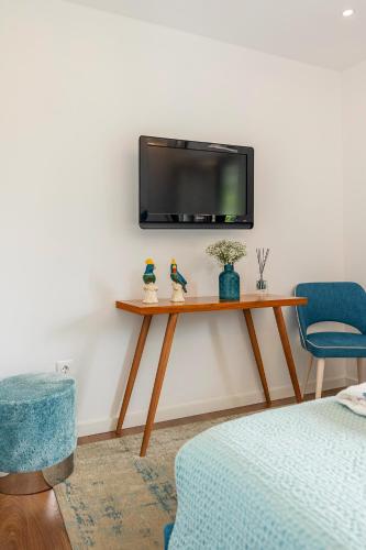 a living room with a tv on a wall at Casa d'Amares in Amares