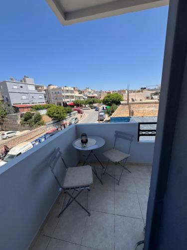 a table and chairs on a balcony with a view at Creta Apt Mela Β5 in Thérissos