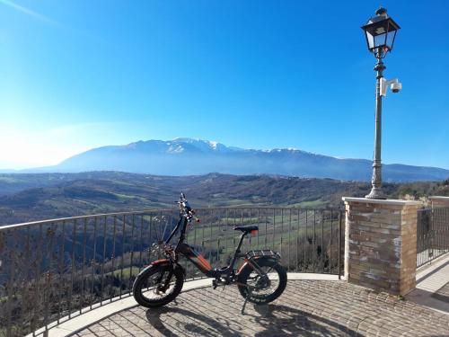 a bike is parked on a balcony with a view at Le Mignole in Orsogna
