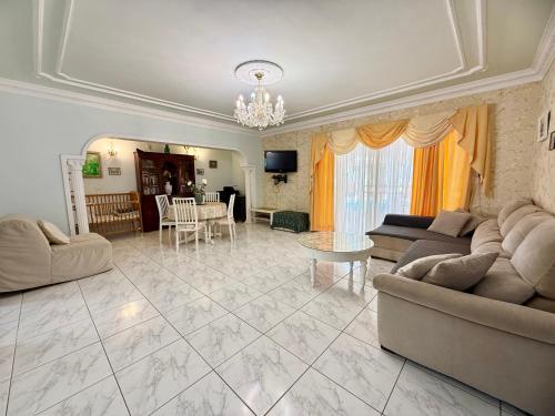 a large living room with couches and a table at Villa Violetta in Callao Salvaje