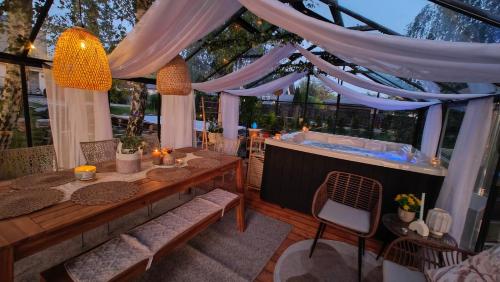 a room with a hot tub and a table and chairs at Domek Zielone Marzenie in Chrzanów