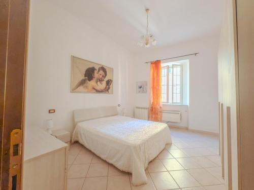 Ένα ή περισσότερα κρεβάτια σε δωμάτιο στο Orbetello Centro - Relax & Mare a Portata di Mano