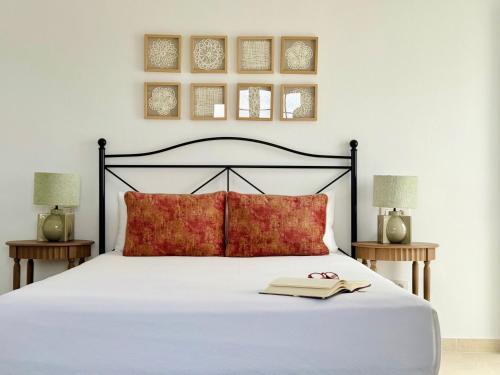 a bedroom with a bed with a book on it at Canaryislandshost I Azucena in Tías