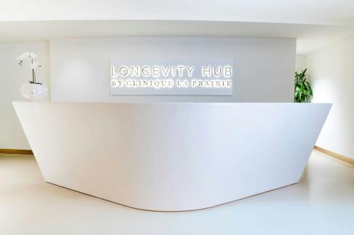 a white counter in a room with a sign on the wall at The St. Regis Marsa Arabia Island, The Pearl Qatar in Doha