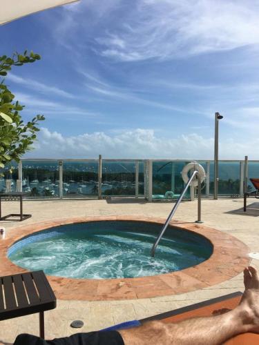 a man is in a pool with a fountain at Private Oasis at Arya in Miami
