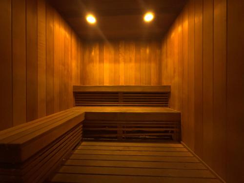 a sauna with wood paneling and two lights on at Private Oasis at Arya in Miami