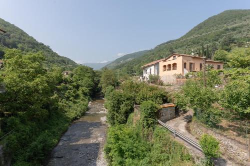 a house on the side of a hill with trees at La Prebeluna da Ceve in Pieve di Teco