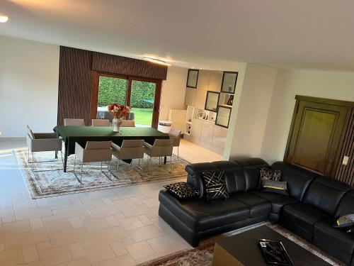 a living room with a couch and a table at Luxe Villa Lou & Hans in Aalst