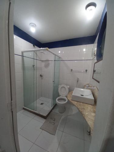 a bathroom with a glass shower and a toilet at Pousada da Bia in Rio das Ostras