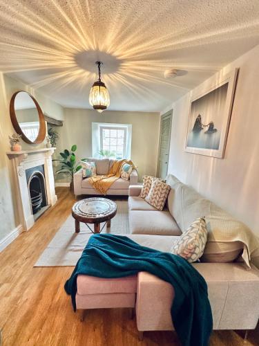 a living room with a couch and a table at Muddy Boots-Arcade Royale in Kirkby Stephen