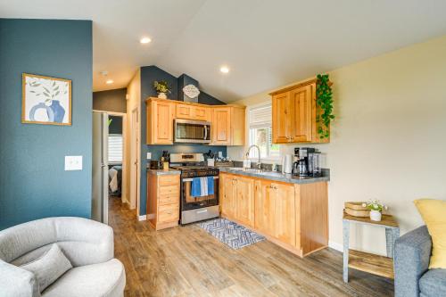 a kitchen with wooden cabinets and a stove top oven at 11 Mi to Port Townsend Ferry Cottage with View! in Port Hadlock