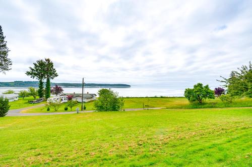 an open field with a view of the water at 11 Mi to Port Townsend Ferry Cottage with View! in Port Hadlock
