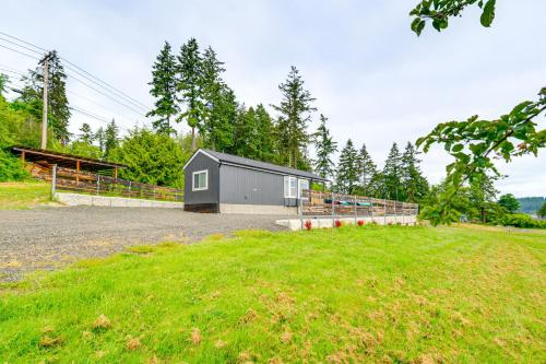 a small gray building in the middle of a field at 11 Mi to Port Townsend Ferry Cottage with View! in Port Hadlock