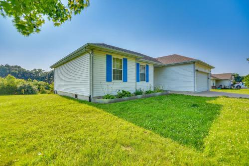 a house with a large lawn in front of it at 2 Mi to Dtwn Fulton Meadowlark Home with Deck! in Fulton