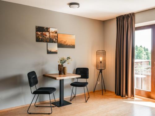 a dining room with a table and chairs at Feriendorf Rosental by S4Y - Selbstversorger Appartements in Feistritz im Rosental