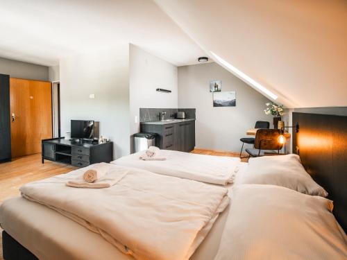 a large bedroom with two beds and a kitchen at Feriendorf Rosental by S4Y - Selbstversorger Appartements in Feistritz im Rosental