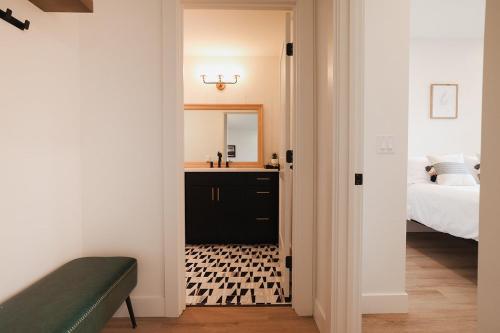 a bedroom with a sink and a bed with a mirror at South Main Residences by Surf Hotel in Buena Vista
