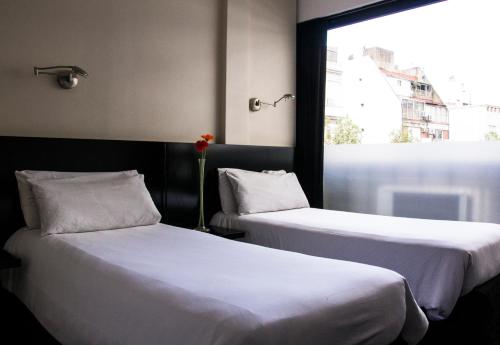 Posteľ alebo postele v izbe v ubytovaní Épico Recoleta Hotel