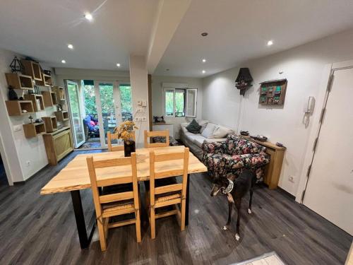 a kitchen and dining room with a table and a couch at Navacerrada, Peace and Pool in Navacerrada