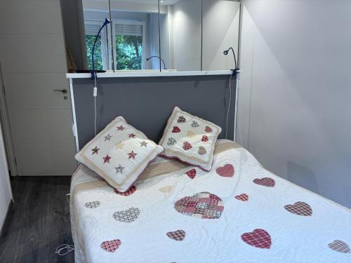 a bed with two pillows on it in a bedroom at Navacerrada, Peace and Pool in Navacerrada