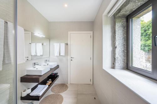 a bathroom with a sink and a mirror at Casa d'Amares in Amares