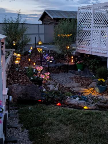 a garden at night with lights on the grass at Granny Zola's Hideaway Bed & Breakfast in Saint Anthony