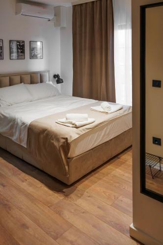 a bedroom with a bed with two towels on it at Garni Hotel Maggitti in Velika Plana