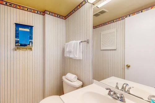 a bathroom with a sink and a toilet and a mirror at Sea Colony - 501 Brandywine House Rd in Bethany Beach