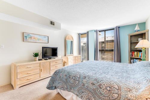 a bedroom with a bed and a tv at Sea Colony - 206 Brandywine House Rd in Bethany Beach