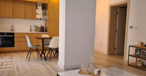 a kitchen and living room with a table and chairs at CityHeart Apartment in Nikšić