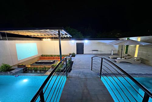 an outdoor swimming pool at night with a swimming pool at Qabala Twins Villa two in Gabala