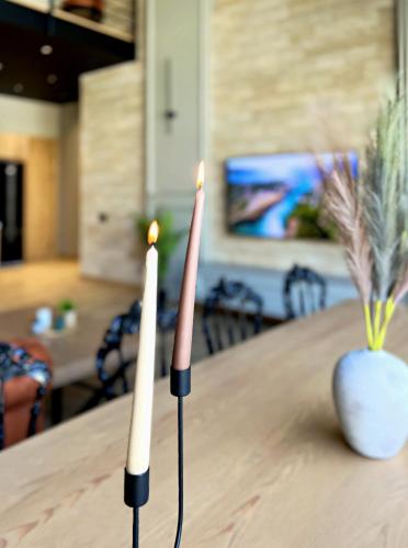 two candles sitting on top of a table at Qabala Twins Villa two in Gabala