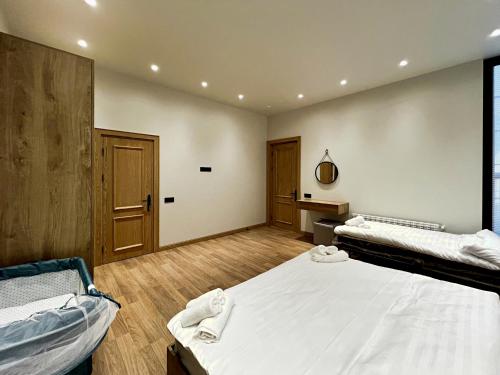 a large room with two beds and a window at Qabala Twins Villa two in Gabala
