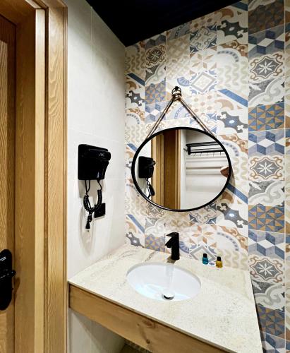a bathroom with a sink and a mirror at Qabala Twins Villa two in Gabala
