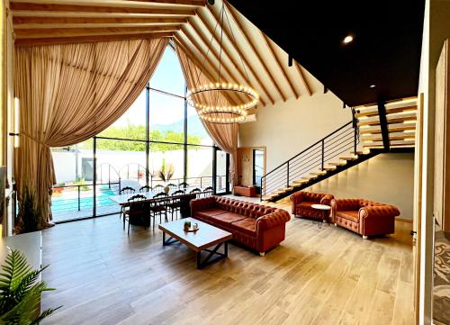 a large living room with couches and a table at Qabala Twins Villa two in Gabala