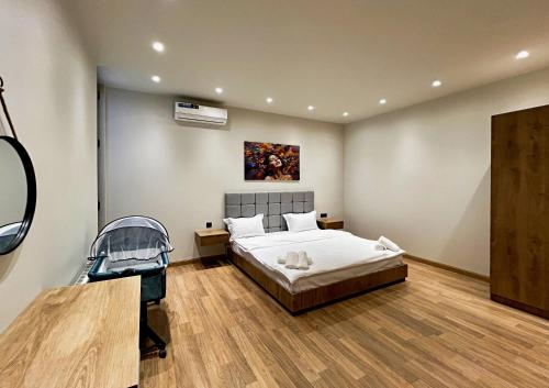 a bedroom with a bed and a painting on the wall at Qabala Twins Villa two in Gabala