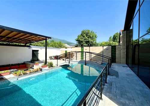 a swimming pool on the balcony of a house at Qabala Twins Villa two in Gabala