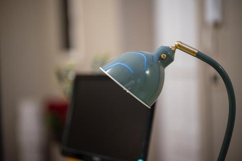 a blue lamp sitting on top of a desk at La zagara di Alba in Palermo