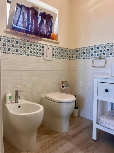 a bathroom with a toilet and a sink at The Blue Window - Rooms - 300m from sea in Augusta