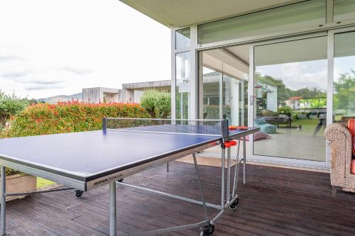 a ping pong table in front of a house at Casa d'Amares in Amares