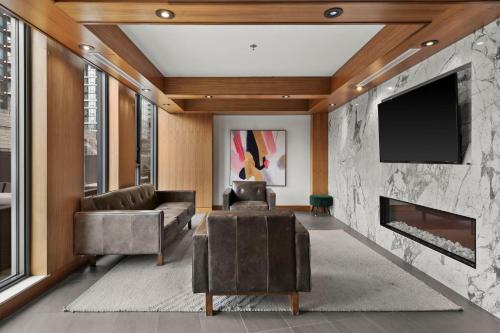 a living room with a fireplace and a tv at GLOBALSTAY Downtown Calgary Apartments in Calgary
