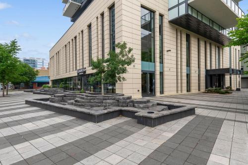 a building with benches in front of a building at GLOBALSTAY Downtown Calgary Apartments in Calgary