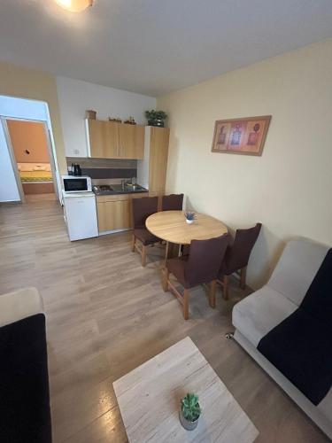 a living room with a table and a kitchen at Apartment Mila in Plitvička Jezera